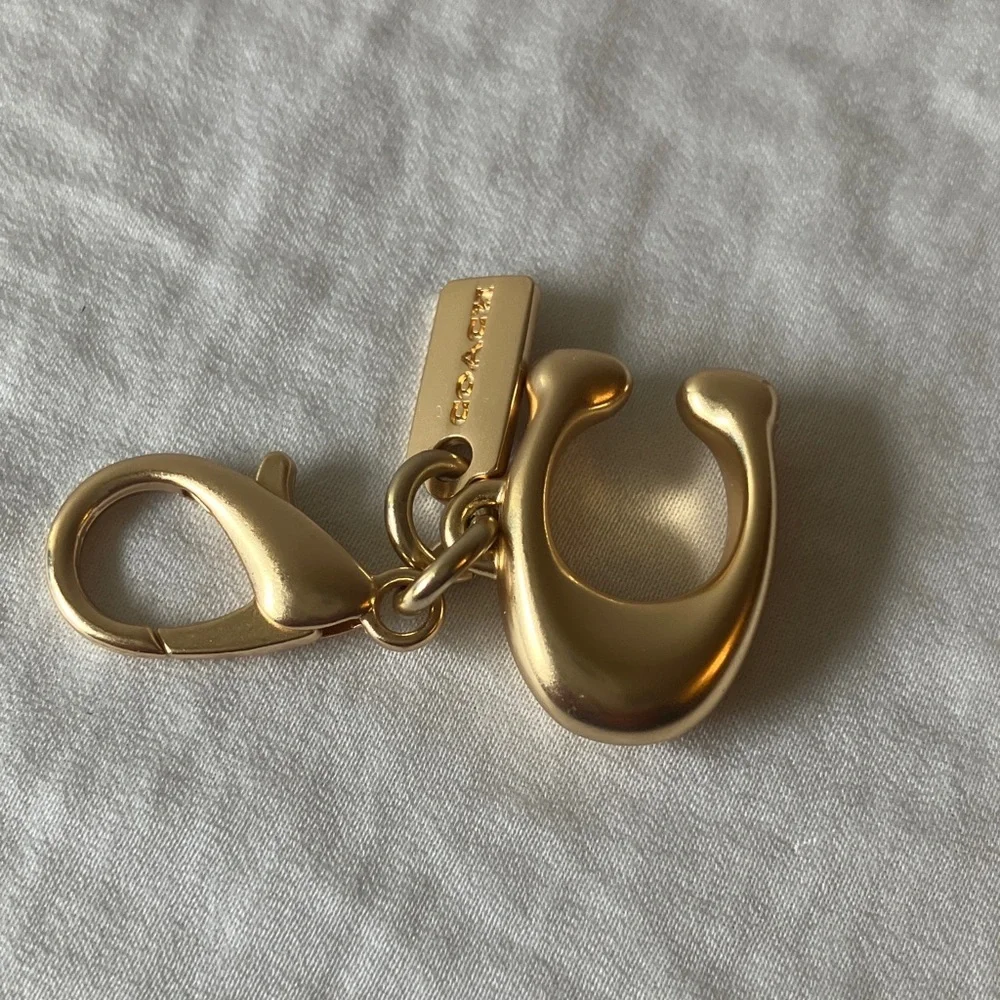 Coach: Metallic Gold Tone Key Holder Charm
